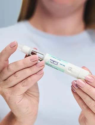 Woman holding Wegovy pen